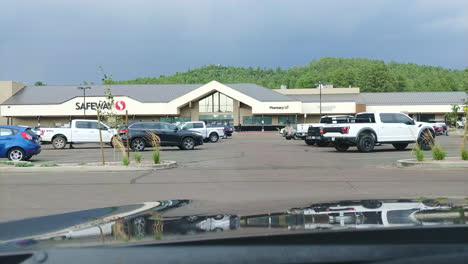 Random-plastic-garbage-passing-by-in-shopping-mall-parking-lot,-POV-view