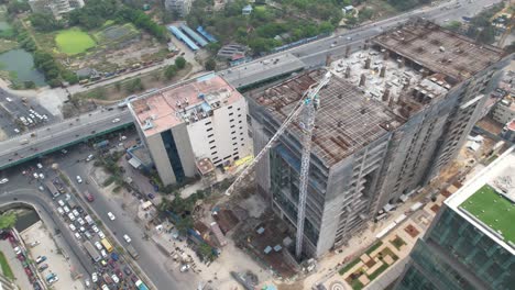 Highway-Aerial-Drone-Footage-of-Corporate-Building-Shell-Under-Construction