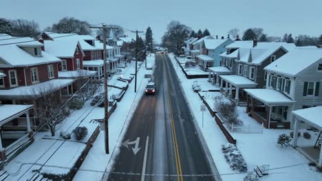 Snow-flurries-falling-on-quaint-town-street-with-historic-homes