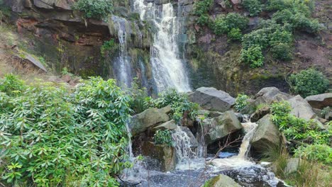 Aerial-drone-footage-of-a-tall-rocky-waterfall-in-the-Yorkshire-Dales,-Pennies