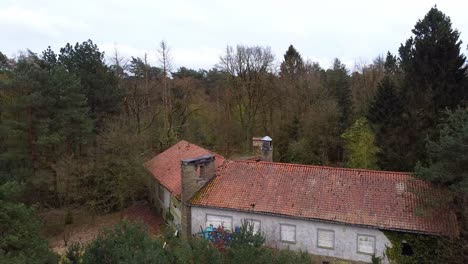 Aerial-view-outside-abandoned-mansion-backside-inside-the-belgian-forest
