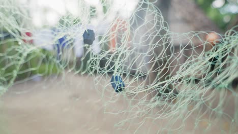 Fishing-net-made-of-green-fibres-in-Madagascar-village,-Africa