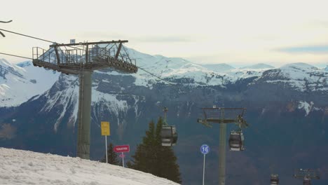 Profile-view-of-Chairlift-system-in-Flaine-ski-resort-in-Flaine,-France-with-beautiful-landscape-at-background-of-French-Alps