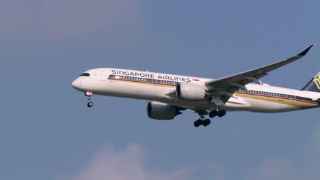 Deploying-its-landing-gears-as-it-prepares-to-land,-the-aircraft-carrier-of-Singapore-descends-to-the-tarmac-of-an-airport-in-Bangkok,-Thailand