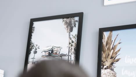 man-hanging-picture-on-the-wall-with-oldshool-yellow-vw-van-car