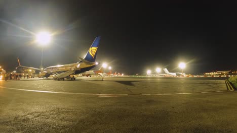 This-time-lapse-shows-Malta-Airport's-apron-bustling-with-aircraft-under-the-bright-lights-just-before-dawn,-readying-for-the-day's-flights