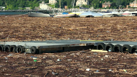 Como,-Italy---july-29-2021---harbour-in-Como,-the-lake-covered-in-timber-and-debris-after-heavy-rains-that-caused-severe-damage-in-the-area