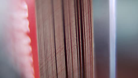 Macro-shot-of-a-pile-of-business-cards-in-stock,-red-card,-super-slow-motion,-Full-HD,-tilt-up-crane-movement