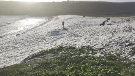 Sea-Foam-blowing-up-kilmurrin-cove-beach-Copper-Coast-Waterford-Ireland