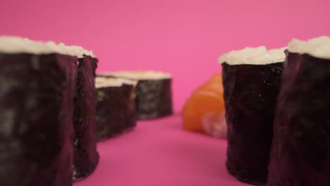 Studio-shot-of-sushi-rolls-on-pink-background