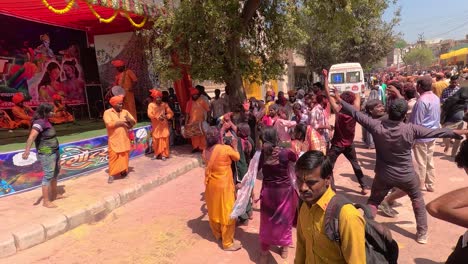 pov-shot-Many-people-are-dancing-in-the-middle-of-the-road-and-enjoying-the-dhuleti-and-many-people-are-also-watching