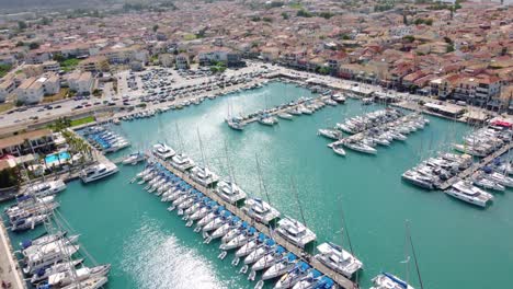 Sailboats-in-D-Marin-Lefkas-Marina-and-the-city-of-Lefkada-island,-Greece