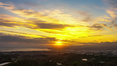 Timelapse-of-majestic-sunset,-golden-city-at-dusk,-Mediterranean-coast-of-Spain