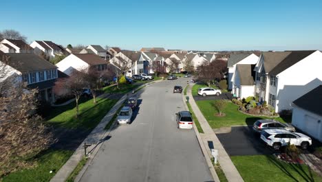 Aerial-birds-eye-shot-of-avenue-with-parking-cars-in-american-residential-area-at-sunset