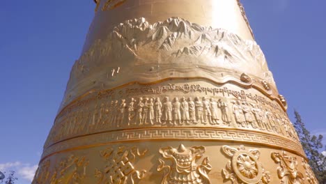 Turistas-Y-Lugareños-Empujando-Para-Hacer-Girar-Una-Rueda-De-Oración-Gigante-En-El-Templo-Dukezong-En-Shangri-la,-Yunnan,-China
