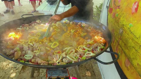 Chef-stirring-tomotoes,-fish,-shrimp-and-muscles-in-Papaya-at-Impressive-Resort-and-Spa,-Punta-Cana,-Dominican-Republic