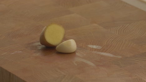 putting-a-ginger-piece-and-a-garlic-clove-on-the-cutting-board