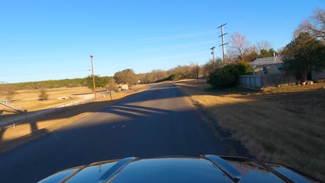 Car-driving-on-FM-473-near-Comfort,-Texas,-USA,-POV-wide-shot
