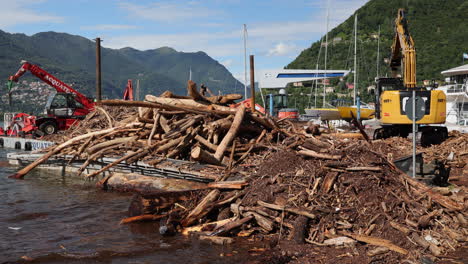 excavators-at-work-for-cleaning-the-lake-from-wood-debris-after-heavy-rains