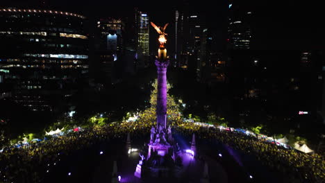 Aerial-view-rising-toward-the-Angel-of-Independence,-New-Years-fireworks-in-Mexico-city