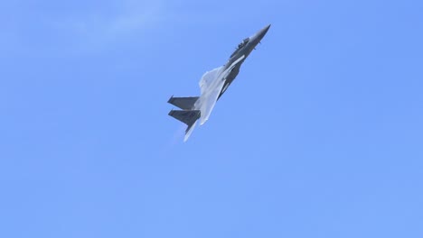 Tracking-Shot-F15-Fighter-Jet-Flying-Against-a-Blue-Sky