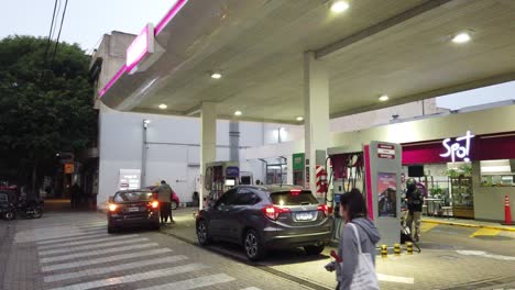 Cars-charging-oil-at-Axion-gas-station-convenience-store-at-buenos-aires-city-night-argentina-people-walk-and-working