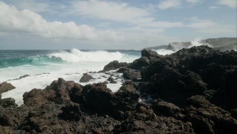 Slowmotion-ocean-waves-crushing-on-sharp-volcanic-rocks-near-Punta-Negra,-Buenavista-del-Norte,-Tenerife,-Canary-Islands-in-spring