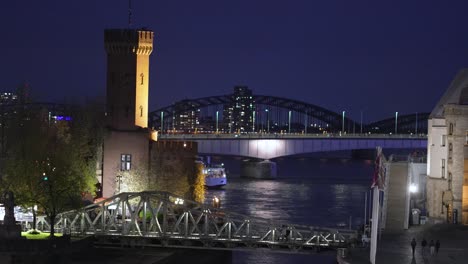 Discover-the-romantic-charm-of-Cologne-at-night,-with-its-historic-landmarks-and-illuminated-bridges-lending-an-air-of-magic-to-the-cityscape