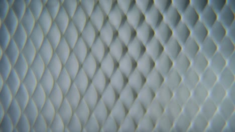 A-dreamy-macro-shot-of-a-metal-grid,-steel-pattern,-iron-industrial-texture,-aluminum-material,-super-slow-motion,-Full-HD-120-fps,-smooth-crane-zoom-out-movement,-blurry-Depth-Of-Field