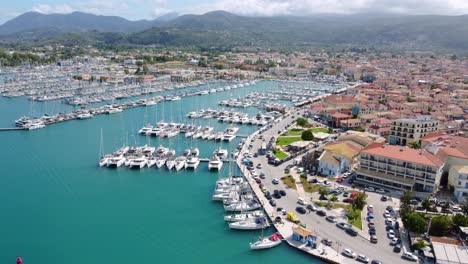 Aerial-view-of-D-Marin-Lefkas-Marina-filled-with-boats-and-ships-and-a-town-of-Lefkada