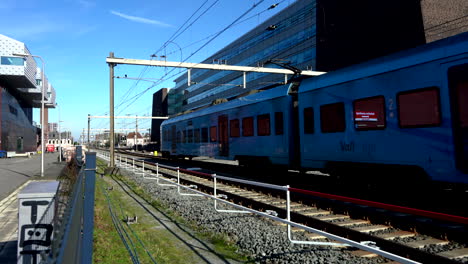 Dutch-trains-rushing-by-at-high-speed,-in-the-Amersfoort-city-Center