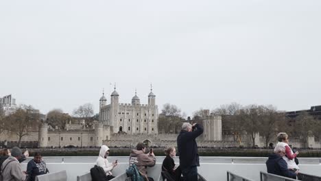 Observing-the-Tower-of-London-from-a-Thames-River-Cruise-in-London,-embracing-the-concept-of-travel-and-exploration,-and-appreciating-its-architectural-grandeur