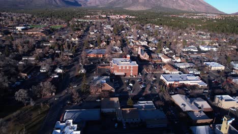 Aerial-View-of-Downtown-Flagstaff-Arizona-USA,-Buildings-and-Landscape-on-Sunny-WInter-Day,-Revealing-Drone-Shot