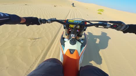 POV,-Riders-racing-at-top-speed-along-sandy-trail