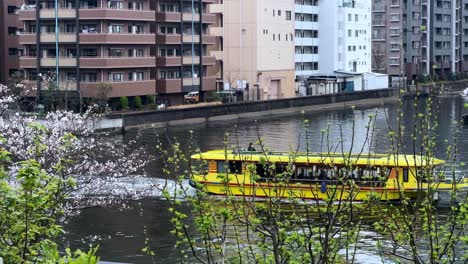 Boat-sailing-at-Ookagawa-Ooka-river-in-Yokohama-scenic-waterfront-buildings-promenade