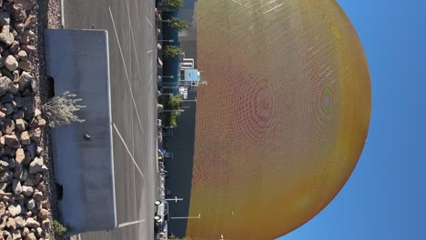 Hyperlapse-of-exterior-of-Sphere-Las-Vegas-in-daytime-with-smiley-face,-vertical-footage