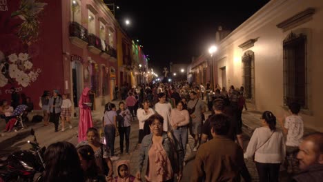 Bustling-pedestrian-corridor-of-Oaxaca-city-filled-with-people-on-the-Day-of-the-Dead