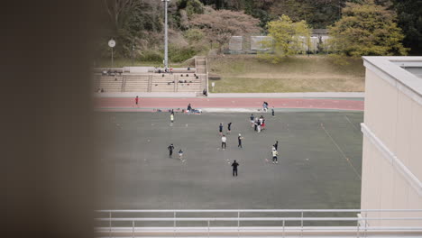 Japanese-youth-rugby-basic-passing-training-on-an-outdoor-sports-ground-on-a-nice-spring-day
