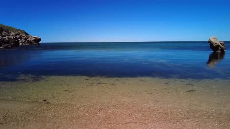 Stillness-by-the-Cliffs:-Calm-Azov-Sea"-captures-the-tranquility-of-gentle-waves-against-rocky-cliffs