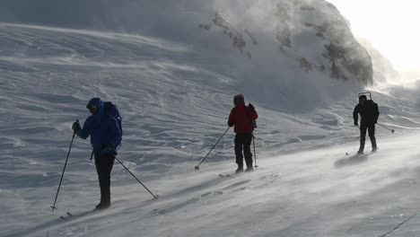 Cross-country-skiers-skiing-through-spring-snow-blizzard-in-Voss,-Norway