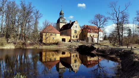 Lielstraupe-Castle-With-Reflection-On-The-Pond-In-Straupe,-Vidzeme,-Latvia