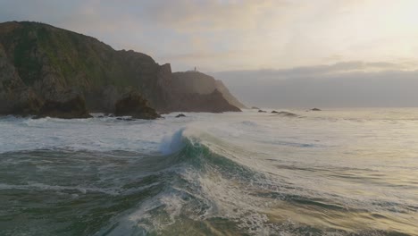 Ocean-wave-crushing-on-remote-cliffs-at-sunset