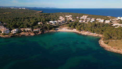 Aerial-view-of-Porto-Colom,-Mallorca,-showcasing-beach-and-coastline