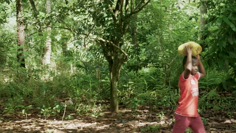 Children-Are-Carrying-Jackfruit-On-Spice-Farm,-Zanzibar,-Unguja-Island,-Tanzania,-Africa