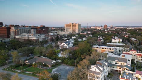 A-drone-shot-of-several-historic-neighborhoods-in-downtown-charleston-south-Carolina-at-sunset