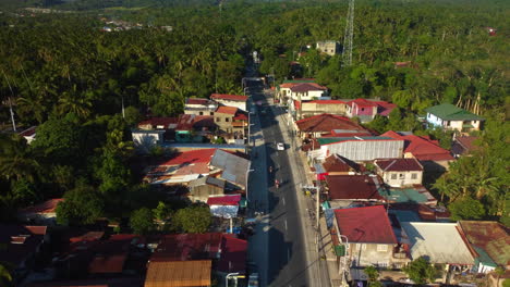 Aerial-view-over-traffic-on-the-streets-in-the-Province-of-Laguna,-golden-hour-in-Philippines