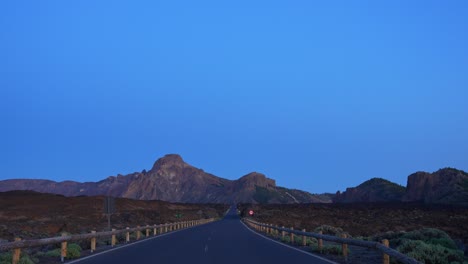 Scenic-mountain-road-in-Tenerife-after-sunset,-handheld-view