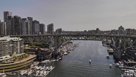 Vancouver-BC-Canada-Aerial-v119-flyover-False-Creek-capturing-Granville-Bridge-traffic,-waterfront-residential,-downtown-cityscape-and-mountain-skyline-views---Shot-with-Mavic-3-Pro-Cine---July-2023