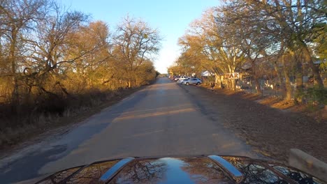 Car-driving-on-Old-San-Antonio-Road-past-Bankersmith,-Texas,-USA,-POV-wide-shot