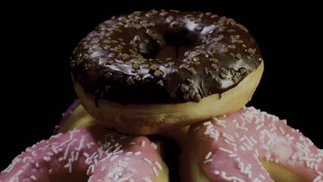 Donuts-with-chocolate-and-pink-icing-sprinkled-with-decorations